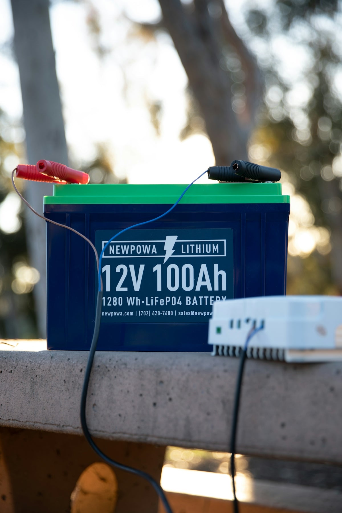 a battery and a charger sitting on a bench