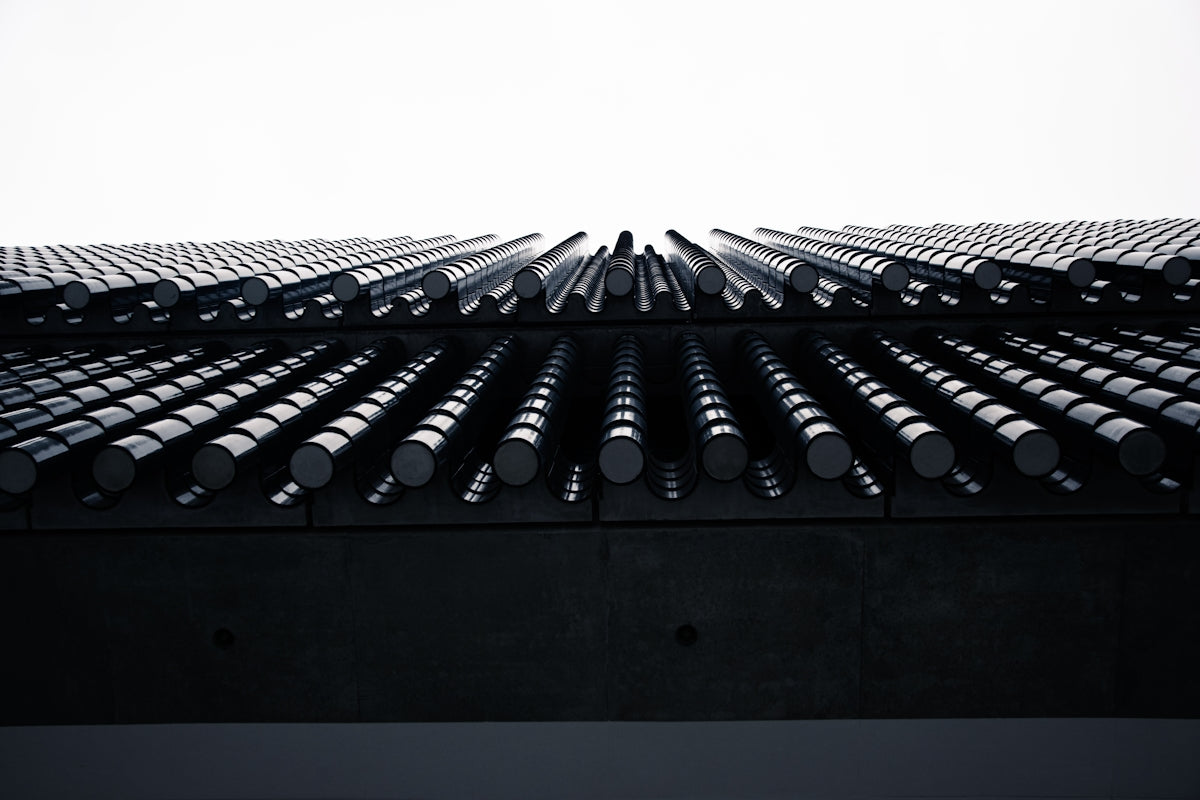 a very tall building with a lot of pipes on top of it