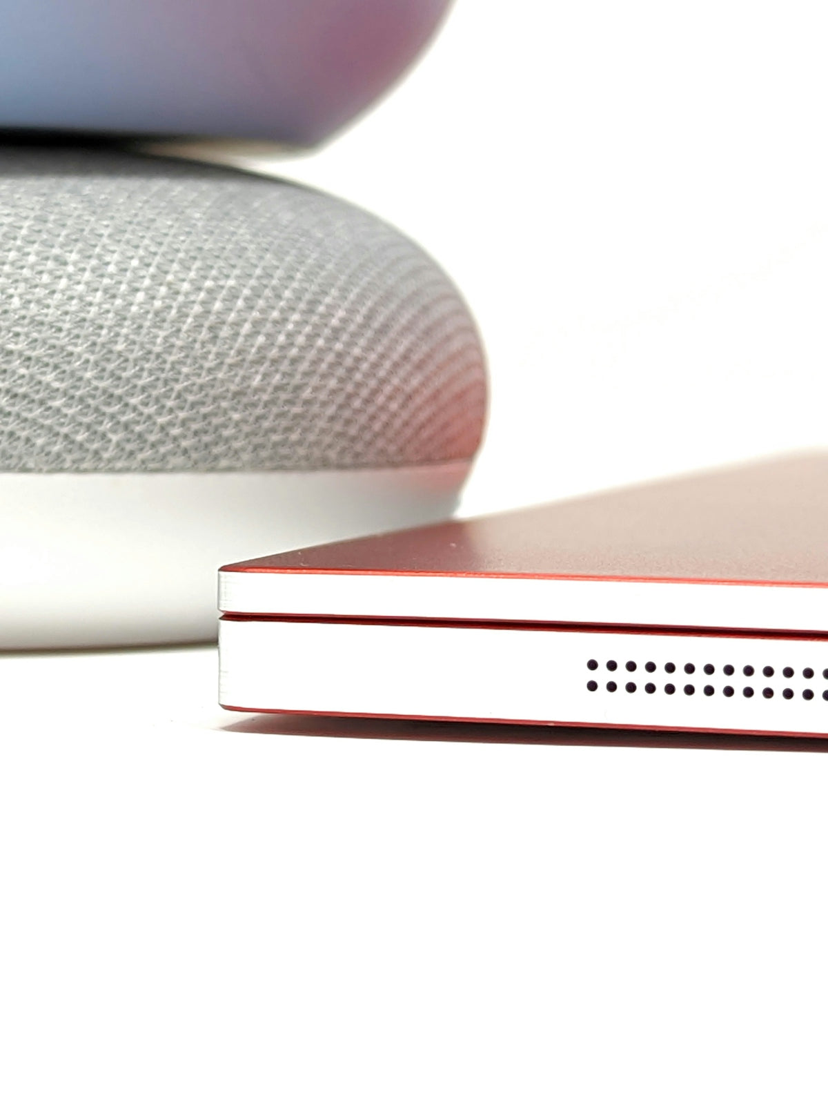 a close up of a red laptop on a white surface