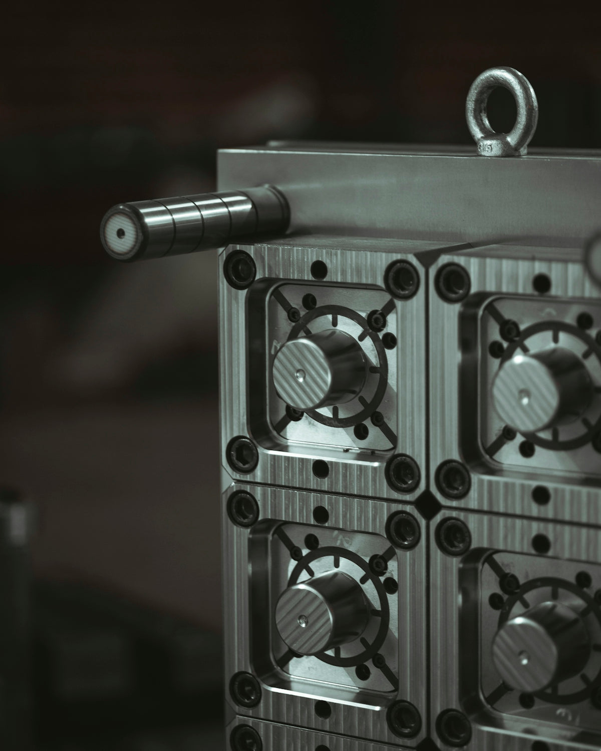 a close up of a metal object with a black and white background