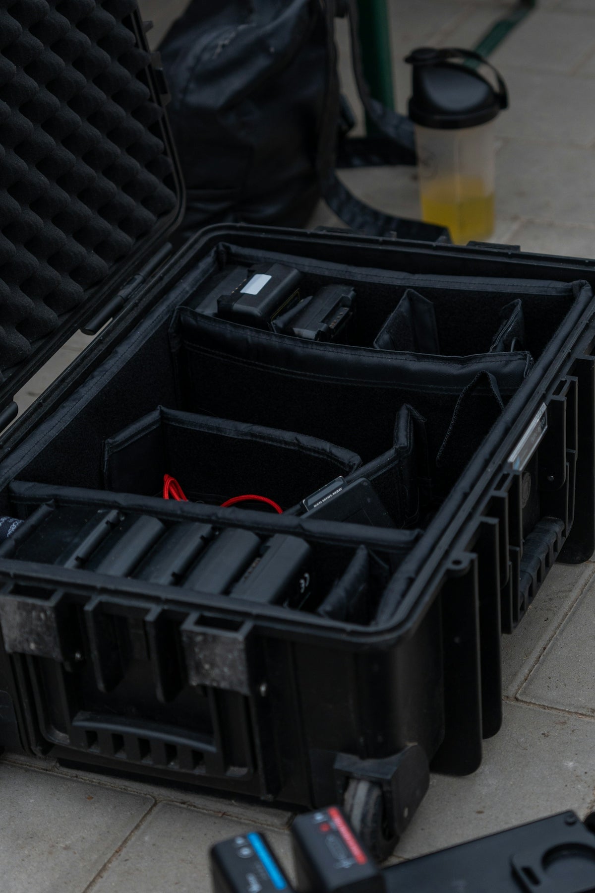 a bunch of black cases sitting on the ground