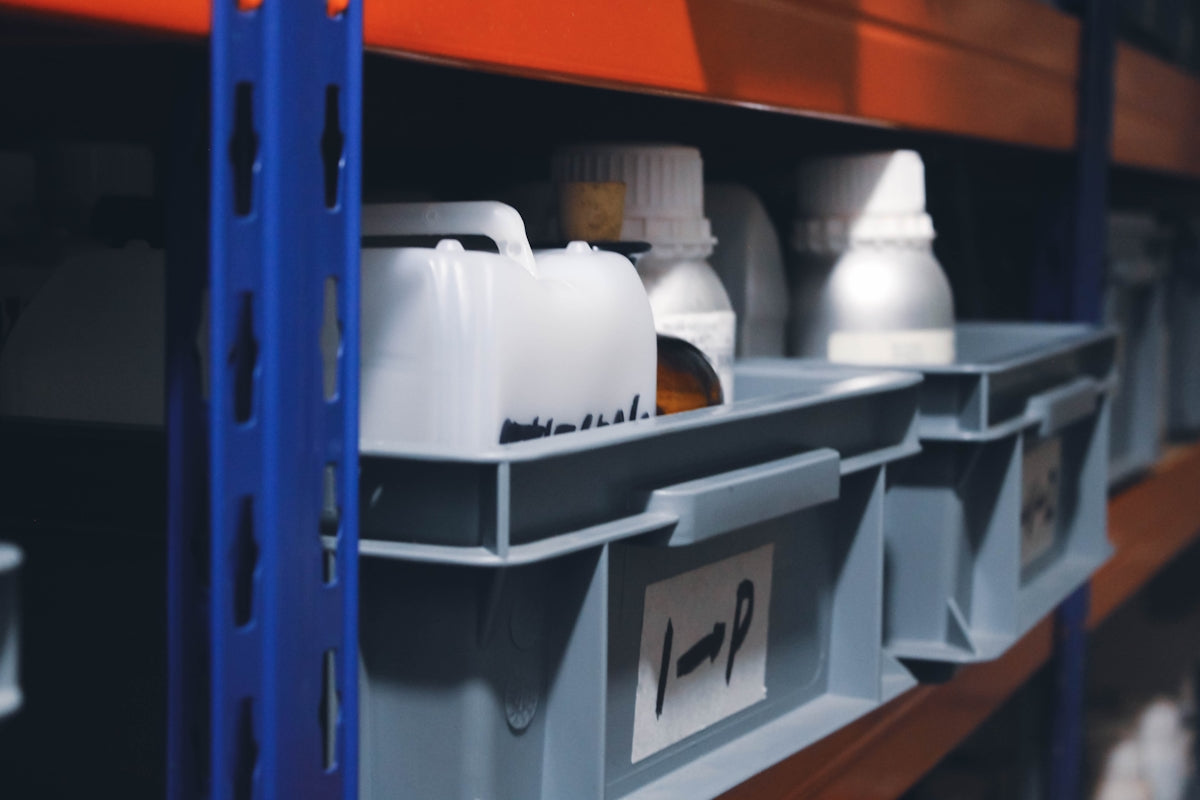 a shelf filled with lots of white and orange containers