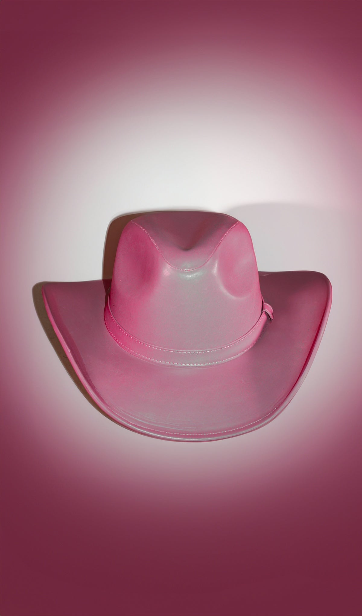 A pink cowboy hat on a pink background