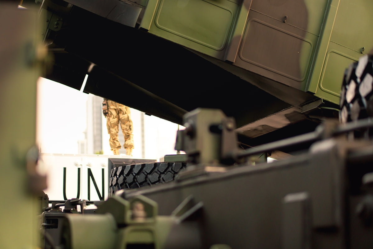 A bunch of green and black suitcases stacked on top of each other