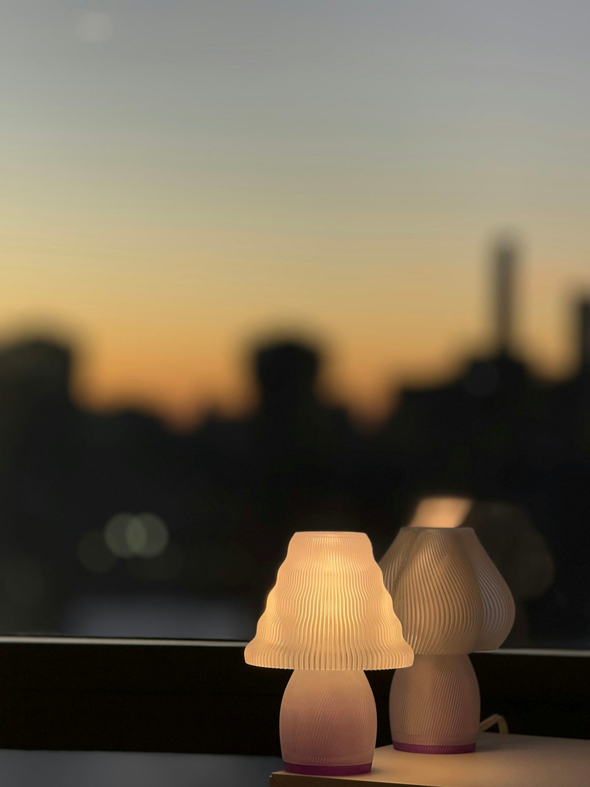 A couple of lamps sitting on top of a window sill