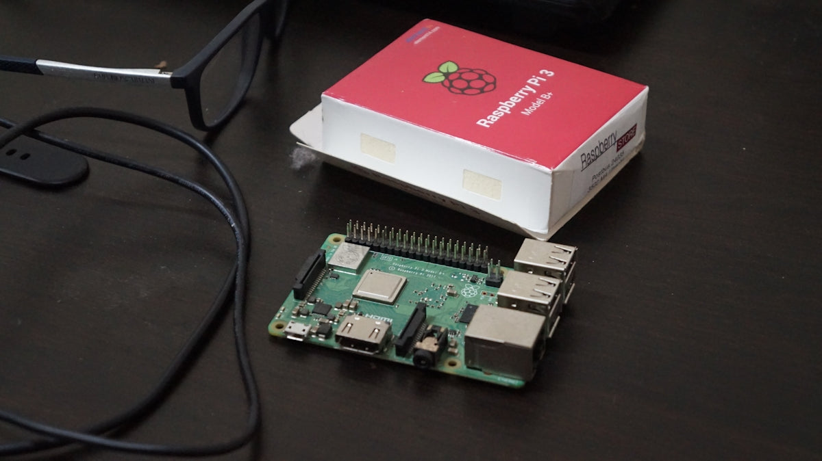 A raspberry board sitting next to a raspberry box
