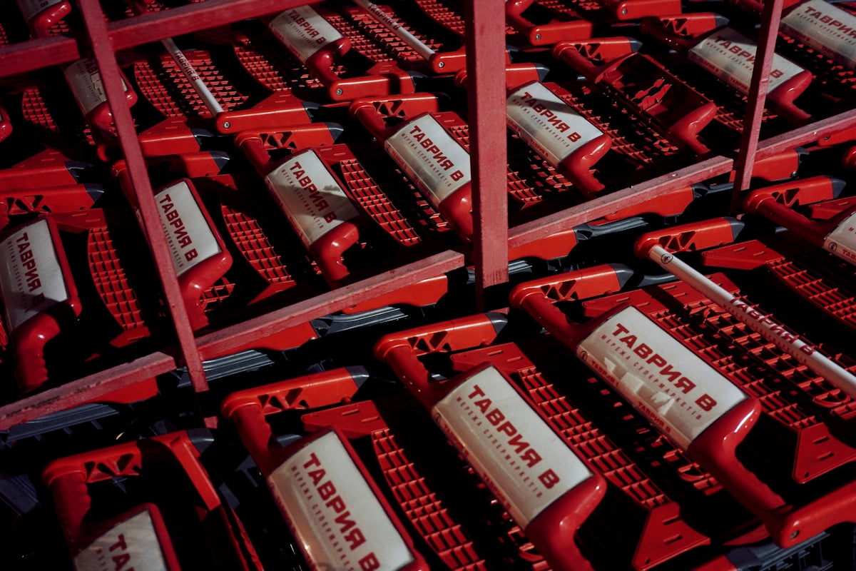 Rows of red shopping carts are packed together.