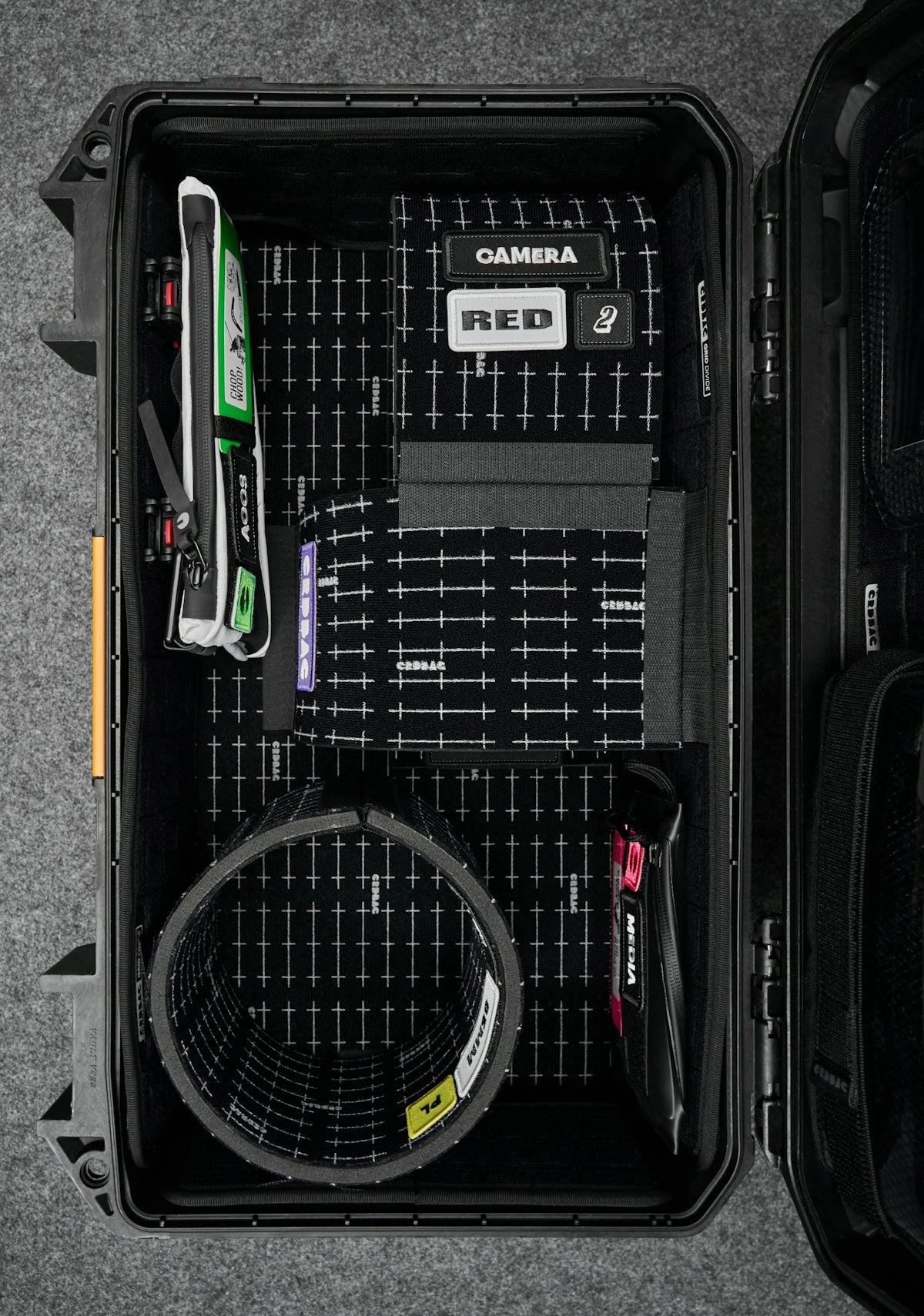 Open black case with camera equipment inside.